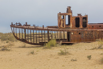 Rusty abandoned ship at the Ship cemetery at the former Aral sea coast in Moynaq (Mo‘ynoq or...