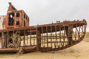 Rusty abandoned ship at the Ship cemetery at the former Aral sea coast in Moynaq (Mo‘ynoq or Muynak), Uzbekistan