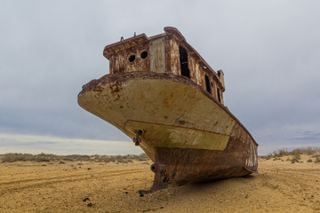 Rusty abandoned ship at the Ship cemetery at the former Aral sea coast in Moynaq (Mo‘ynoq or...