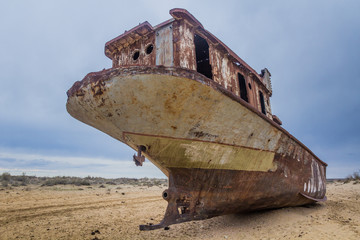 Rusty abandoned ship at the Ship cemetery at the former Aral sea coast in Moynaq (Mo‘ynoq or Muynak), Uzbekistan