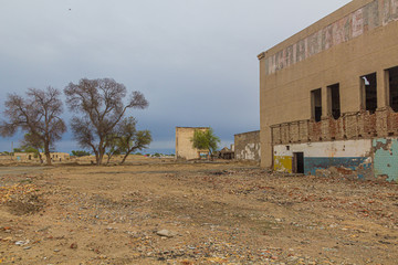 Ruins of abandoned fish canning factory in former Aral Sea port town Moynaq (Mo‘ynoq or Muynak), Uzbekistan