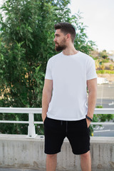 Casual model man outdoors., Very handsome, with a white t-shirt and urban style