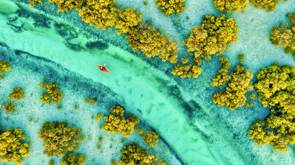Aerial view of a person with kayak crossing Abu Al Sayayif natural reserve, Abu Dhabi, United Arab Emirates