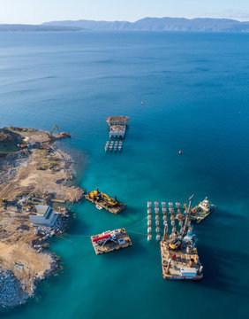 Aerial view of machinery at the construction of future LNG terminal on the shore of the bay in Omisalj, Croatia