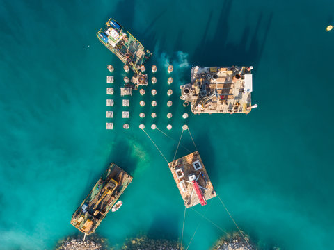 Aerial view of machinery on concrete platforms at the construction of future LNG terminal on the shore of the bay in Omisalj, Croatia