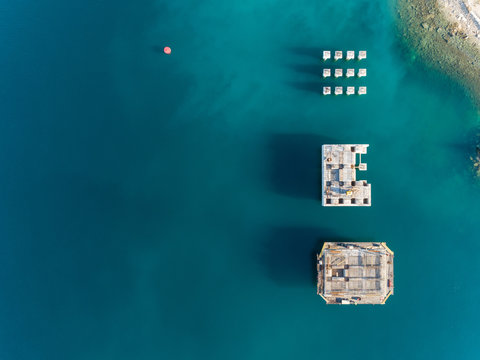 Aerial view of concrete platforms at the construction of future LNG terminal on the shore of the bay in Omisalj, Croatia