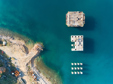 Aerial view of concrete platforms at the construction of future LNG terminal on the shore of the bay in Omisalj, Croatia