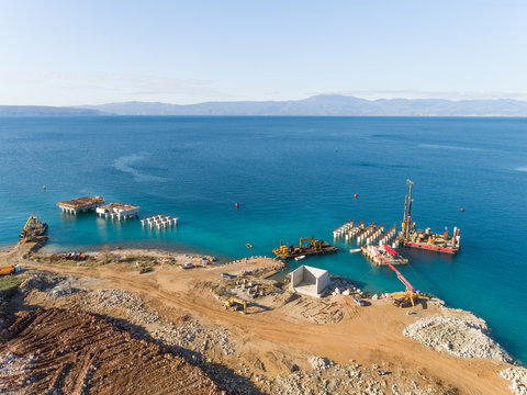 Aerial view of machinery at the construction of future LNG terminal on the shore of the bay in Omisalj, Croatia