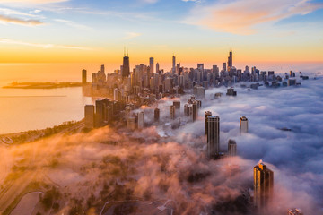 Aerial view of fog covering over Chicago skyscraper during sunset
