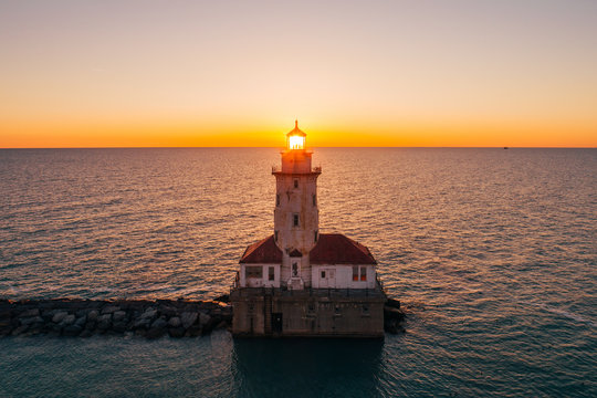 Aerial view of Chicago Harbor Lighthouse during scenic sunset, United States.