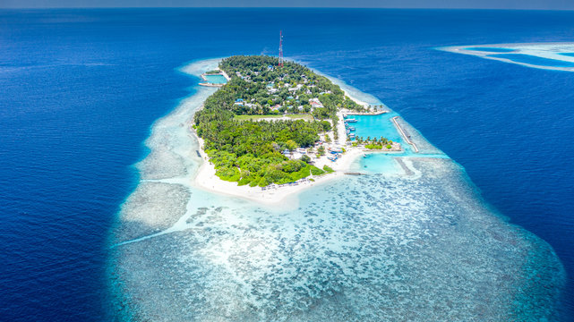 Aerial view of local island Hangnaameedhoo, located in Ari Atoll, Maldives, Indian Ocean with reef, harbour, local beach, bikini / guest beach