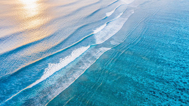 Aerial view of calm waves, breaking at the reef of the local / inhabited island of  Mathiveri, Maldives, Alif Alif Atoll, Indian Ocean