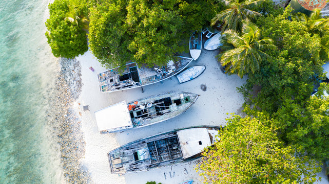Aerial view of abandoned boats, dhonis at the local shore of local island Omadhoo, Alif Dhaal Atoll, Maldives, Indian Ocean