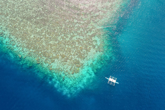 Aerial view of  Reef with Boat in front of CYC Beach,Coron,Palawan,Philippines.