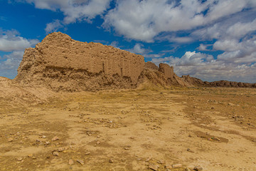 Fototapeta na wymiar Earoded earthen walls of Ayaz Qala fortress in Kyzylkum desert, Uzbekistan