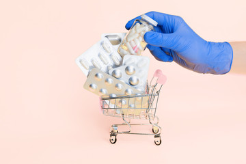 shopping basket with pills, antibiotic isolated on pink. delivery service of online order from pharmacy. female painkiller tablet, menstruation, contraception, climax, pregnancy, progesterone, pms.