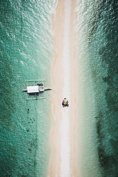 Aerial view of a sandy path in the middle of the sea in Talibon, Bohol, Philippines