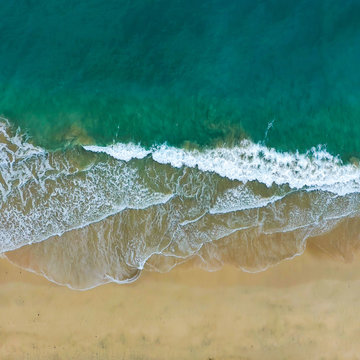 Aerial view of waves crashing on a beach in Fuerteventura spain with vivid colours