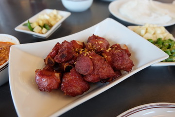 Close up fried fermented pork ribs, deep fried sour pork ribs on a white plate. Thai food.