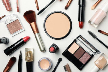 Different makeup cosmetics on white background, top view