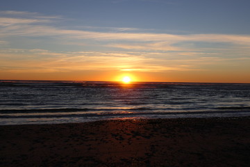 Sun sinks at the horizon of the Tasman Sea, observed from New Zealand's west coast