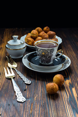 Cup of tea and donuts on wooden table