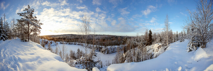 Winter landscape of snow-covered forest and frozen lake