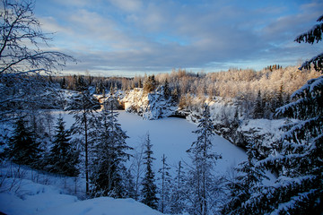 Fototapeta na wymiar Winter landscape of snow-covered forest and frozen lake
