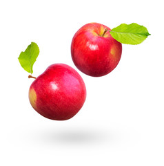 Red apples with green leaves fly on a white background. Natural fresh product