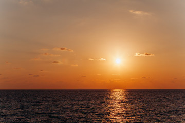 Beautiful sunset above the sea. Reflection of sunset in the water.