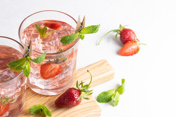 Mojito cocktail with strawberries and mint. Summer aromatic refreshing cocktail.