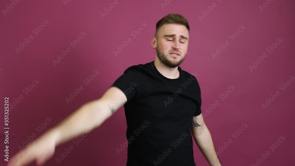 Wall mural Displeased man taking off his cap and throwing it away against color background