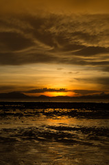 sunset at the beach with scared cloud