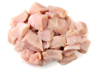 pile of fresh diced and sliced raw chicken breast, cube form, isolated on white background