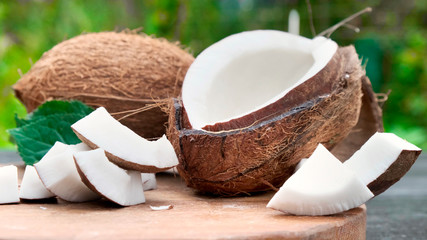 Pouring fresh coconut milk on wooden table.