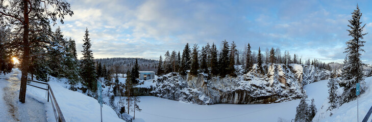 Winter landscape of snow-covered forest and frozen lake