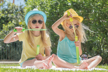Two sisters playing in the garden, Summertime fun