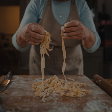 grandmother prepares homemade noodles