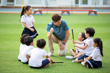 Foreign teacher teaching golf