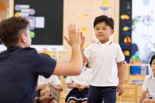 Foreign teacher teaching children English in classroom