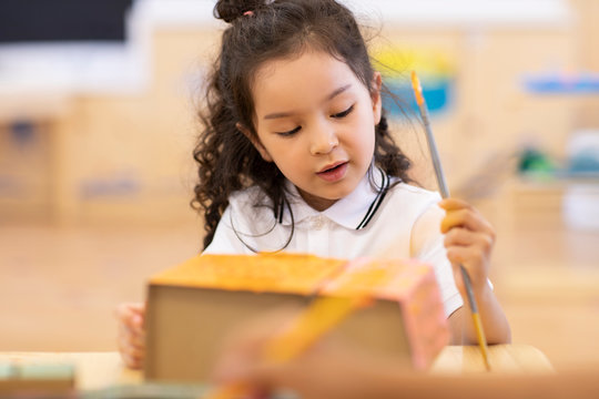 Little girl having art class in classroom - Powered by Adobe