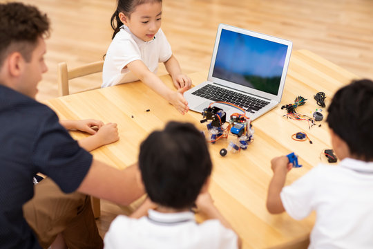 Children learning coding in classroom