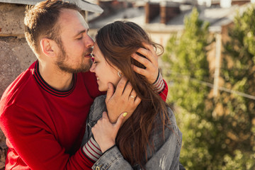 Close-up portrait of lovers man and women. A man kisses his wife on the forehead with his eyes closed. Kiss with eyes closed.