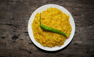 Khichdi Dish with Chilli in a Plate Isolated on Wooden Background, Also Known as Khichuri or Khichri