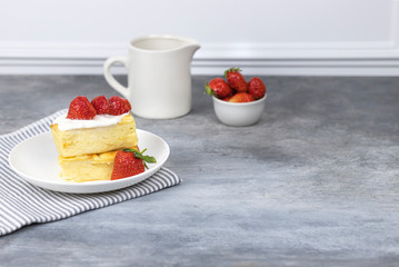 cottage cheese casserole with cream and strawberries on a white plate