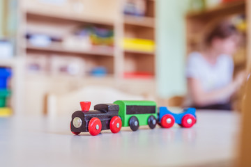 Children development concept: Close up of wooden toy railroad in the kindergarten