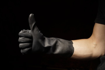 Hand gestures industrial black rubber gloves for personal safety hand wearing the personal protective equipment - ppe hygiene