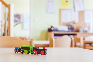 Children development concept: Close up of wooden toy railroad in the kindergarten
