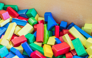 Playing with wooden toy blocks in kindergarten or preschool