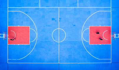 view on basketball court from drone. people playing basketball